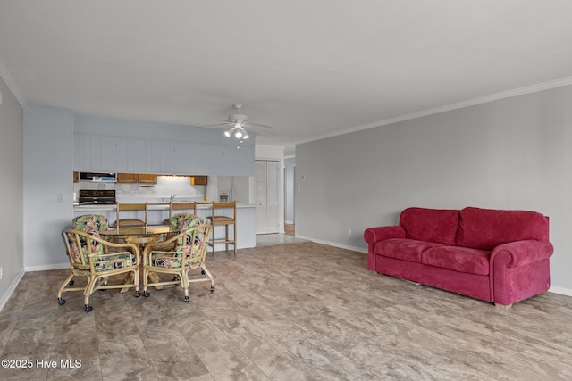 dining room featuring crown molding, sink, and ceiling fan