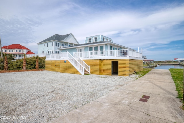 view of front facade featuring covered porch and a water view