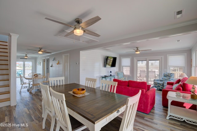 dining space featuring hardwood / wood-style flooring and ornamental molding