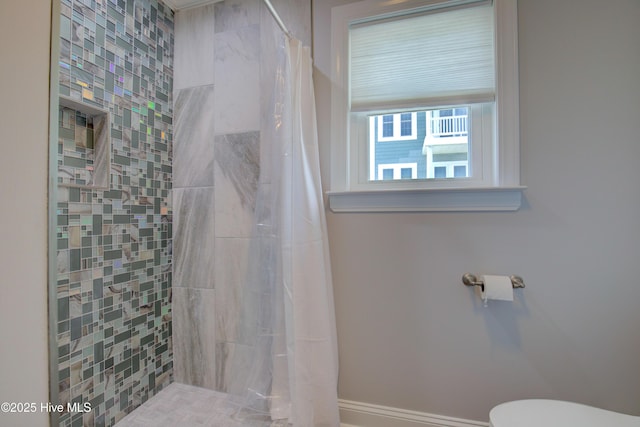 bathroom with toilet and curtained shower