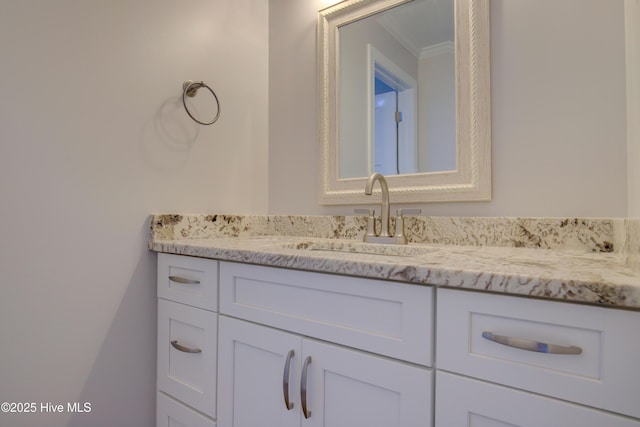 bathroom featuring vanity and crown molding