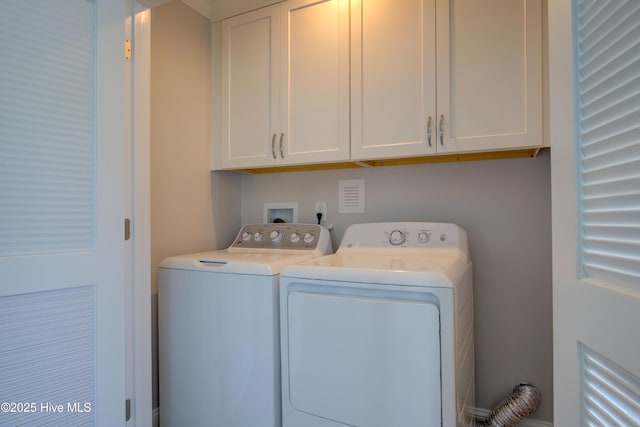 laundry room with cabinets and washer and dryer