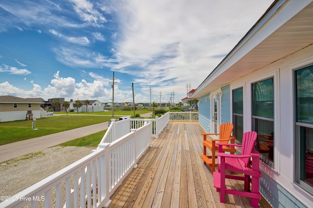 wooden terrace with a lawn