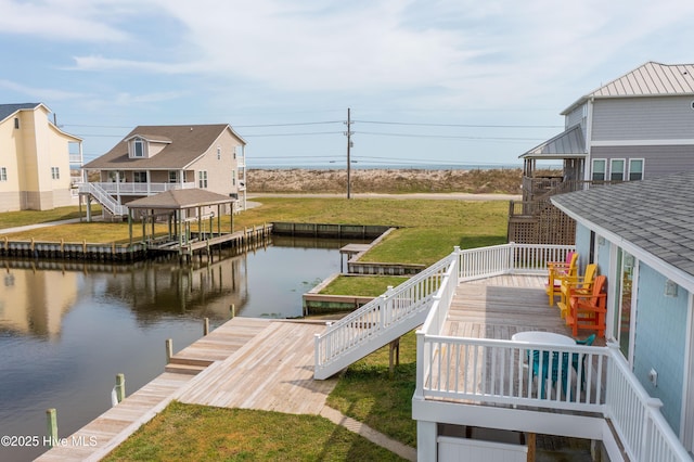 view of dock featuring a lawn and a deck with water view