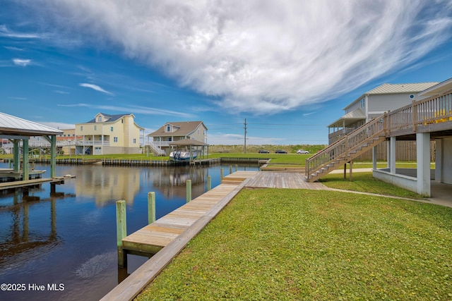 dock area with a lawn and a water view