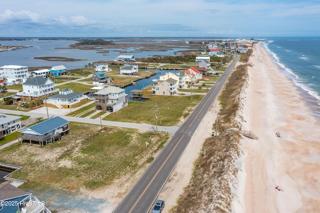 bird's eye view with a water view and a view of the beach