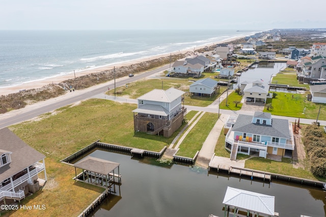 drone / aerial view with a water view and a view of the beach