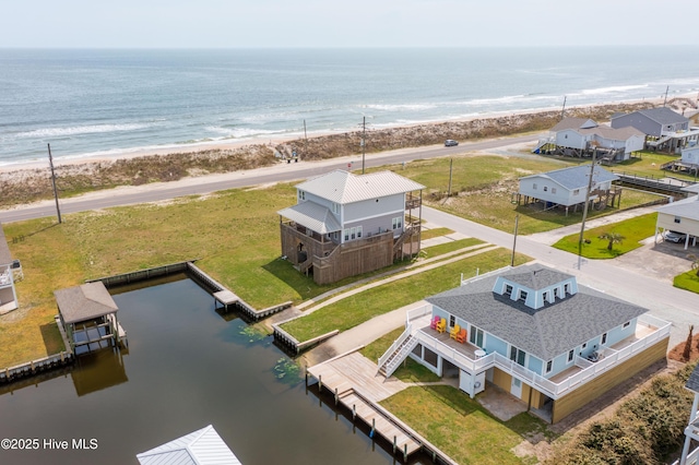 bird's eye view with a water view and a beach view