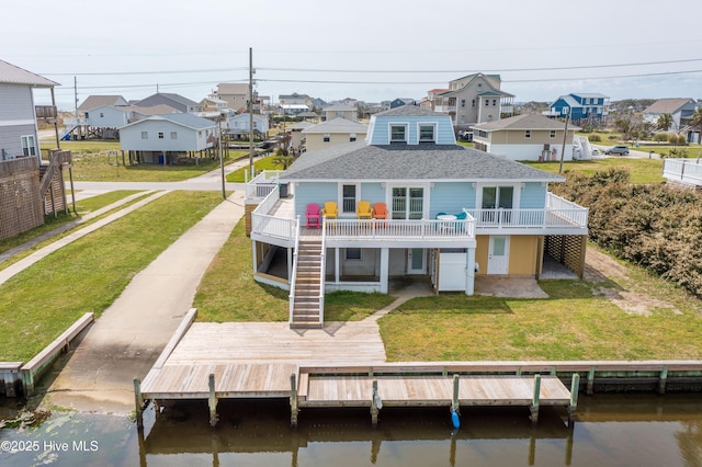 back of house featuring a deck and a yard