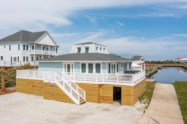 exterior space featuring a deck with water view