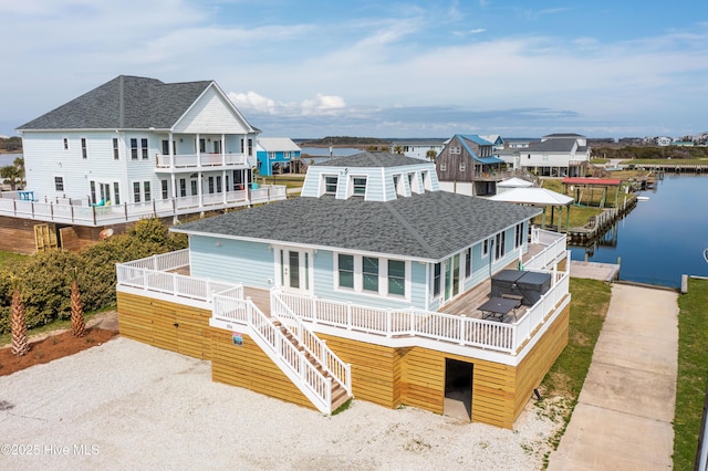 back of house with a balcony and a water view