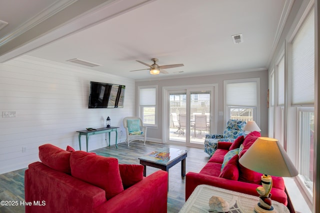 living room featuring crown molding, hardwood / wood-style floors, and ceiling fan