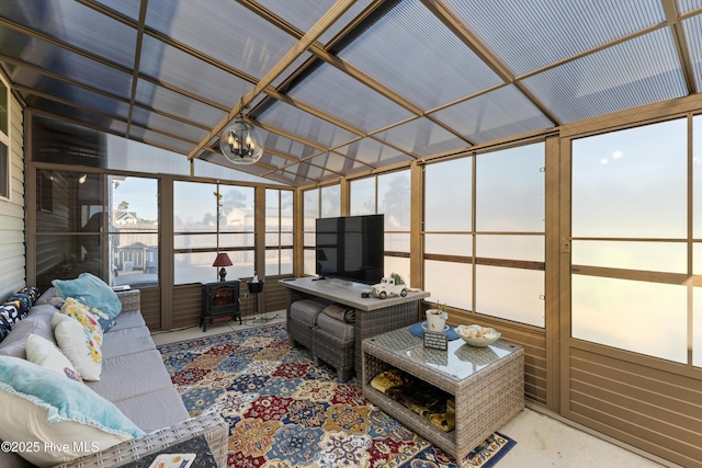 sunroom featuring a notable chandelier and vaulted ceiling