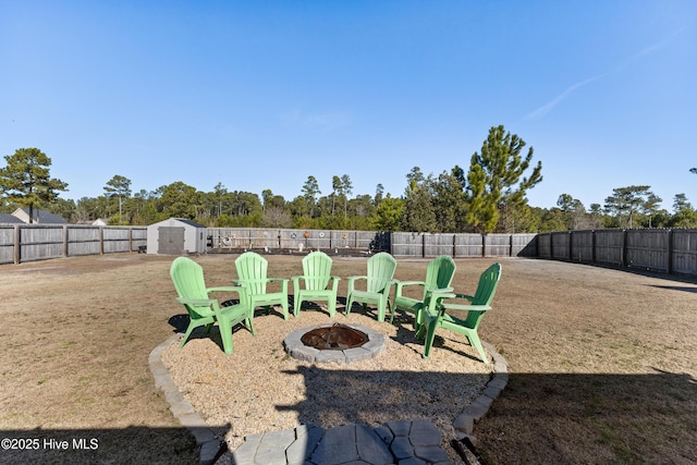 view of yard featuring a storage unit and an outdoor fire pit