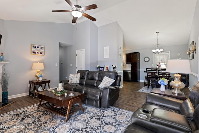 living room featuring dark hardwood / wood-style floors, ceiling fan with notable chandelier, and high vaulted ceiling