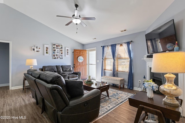 living room featuring hardwood / wood-style flooring, vaulted ceiling, and ceiling fan