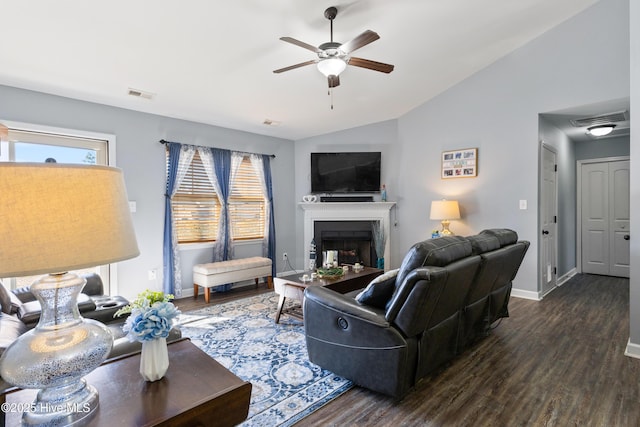 living room featuring dark wood-type flooring, ceiling fan, and lofted ceiling