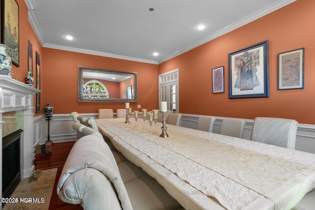 dining room featuring recessed lighting, wood finished floors, a high end fireplace, and crown molding