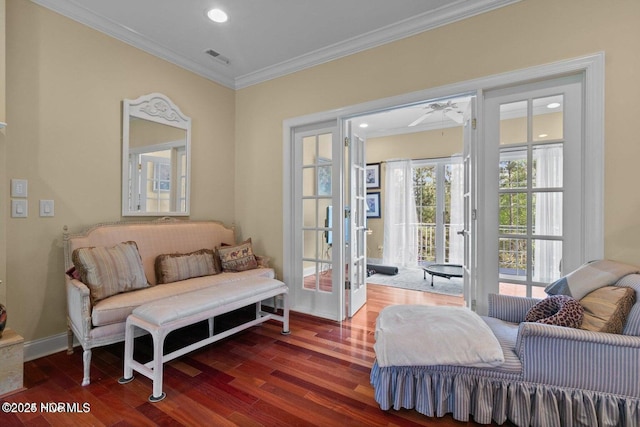 sitting room with baseboards, ornamental molding, wood finished floors, and french doors