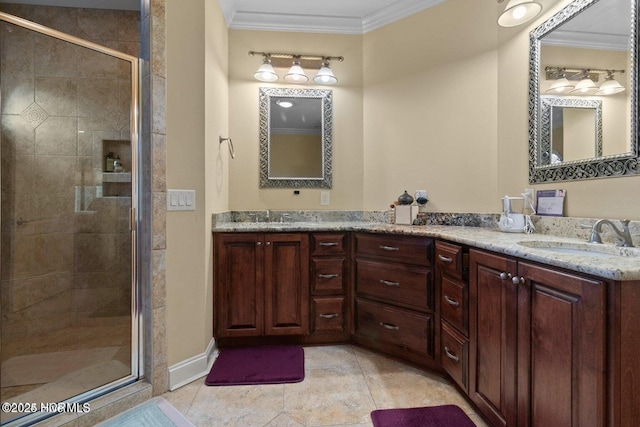 bathroom featuring tile patterned flooring, a sink, a shower stall, double vanity, and crown molding