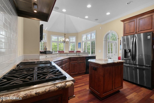 kitchen with light stone counters, a sink, dishwasher, and stainless steel fridge with ice dispenser