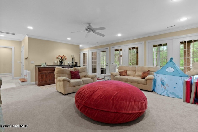 living room featuring recessed lighting, french doors, light colored carpet, and crown molding