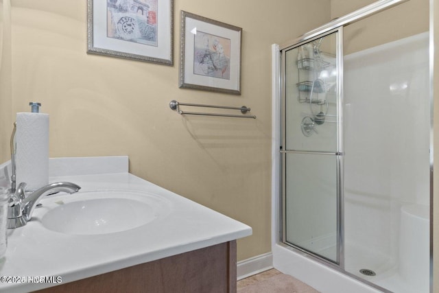 bathroom featuring a sink and a shower stall