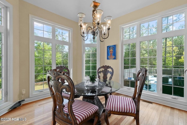 sunroom featuring an inviting chandelier