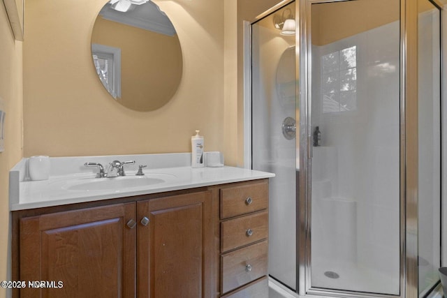 bathroom with ornamental molding, a shower stall, and vanity