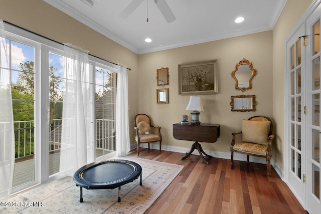 sitting room with ornamental molding, recessed lighting, baseboards, and wood finished floors