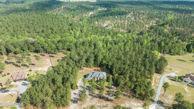 bird's eye view featuring a wooded view