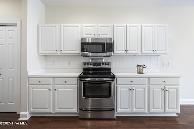 kitchen featuring decorative backsplash, white cabinets, appliances with stainless steel finishes, and dark hardwood / wood-style floors