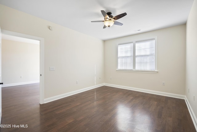 spare room featuring ceiling fan and dark hardwood / wood-style flooring