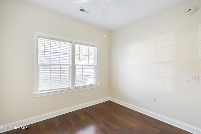 spare room with ceiling fan, plenty of natural light, and dark hardwood / wood-style flooring