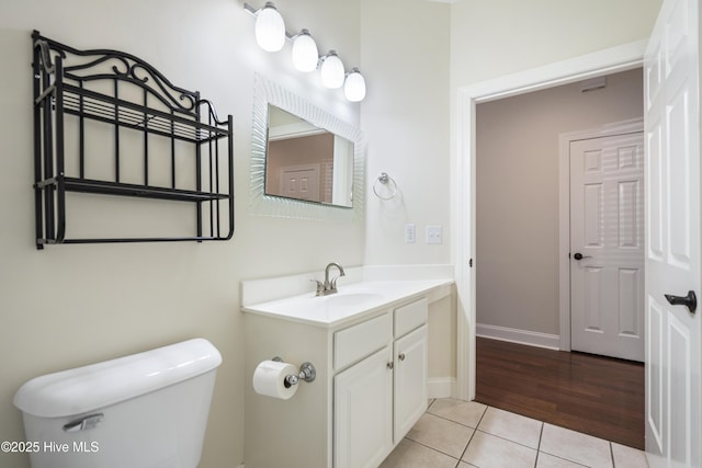 bathroom featuring vanity, toilet, and tile patterned floors