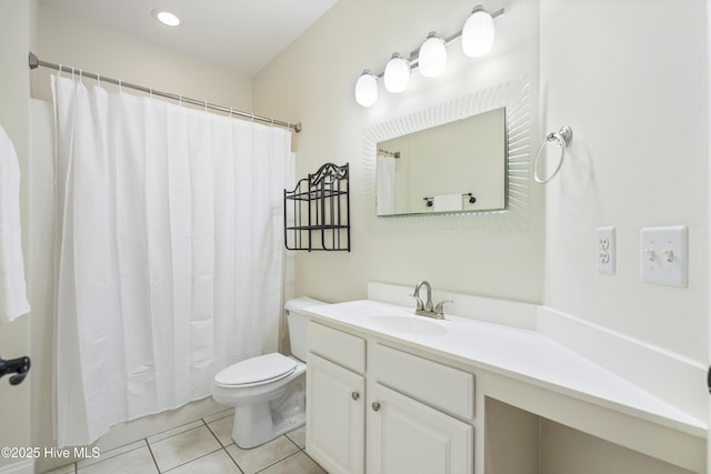 bathroom featuring tile patterned floors, vanity, and toilet