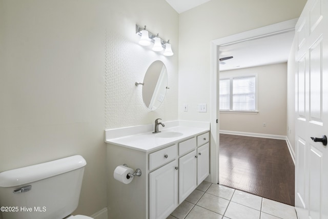 bathroom with toilet, tile patterned floors, and vanity