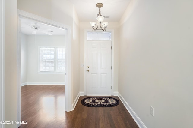 entryway with hardwood / wood-style flooring and ceiling fan with notable chandelier