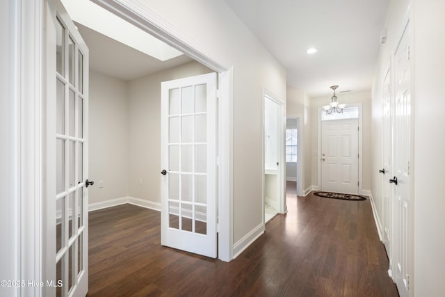 corridor with french doors and dark hardwood / wood-style flooring