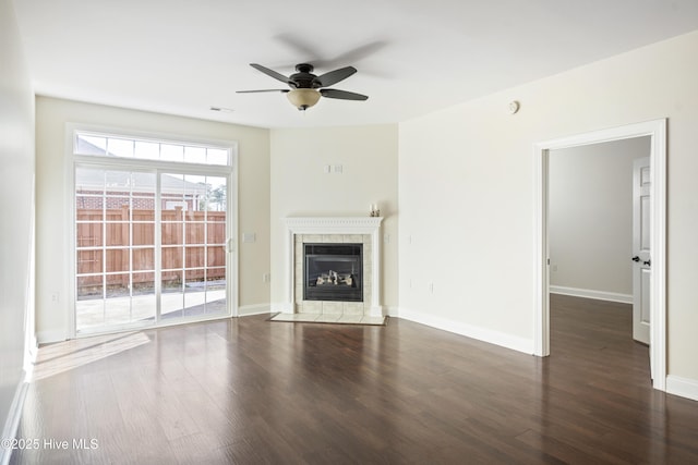 unfurnished living room with ceiling fan, dark hardwood / wood-style flooring, and a fireplace