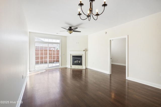 unfurnished living room with ceiling fan, dark hardwood / wood-style floors, and a tile fireplace