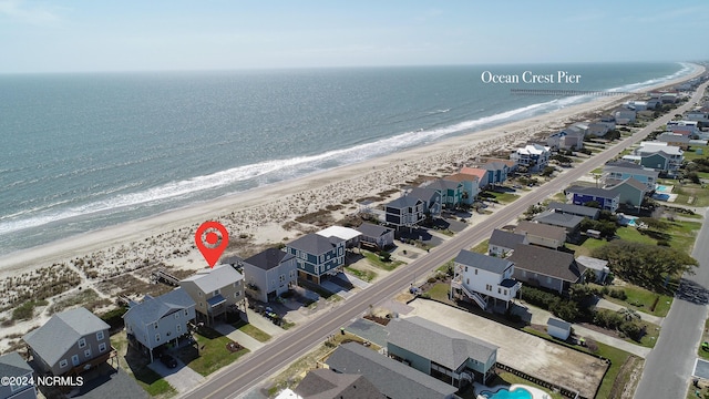 drone / aerial view featuring a water view and a beach view