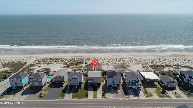 bird's eye view with a water view and a beach view