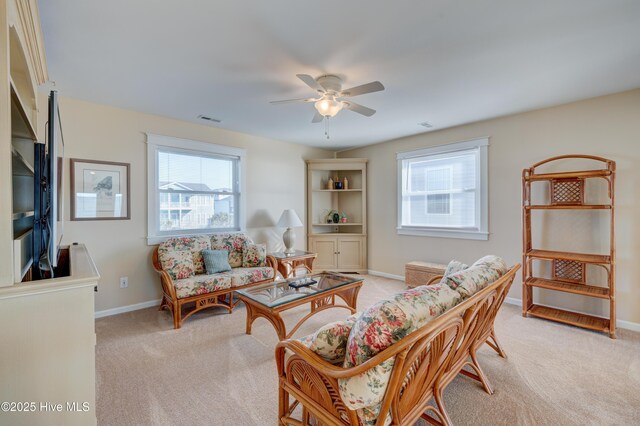 carpeted living room featuring ceiling fan and a healthy amount of sunlight