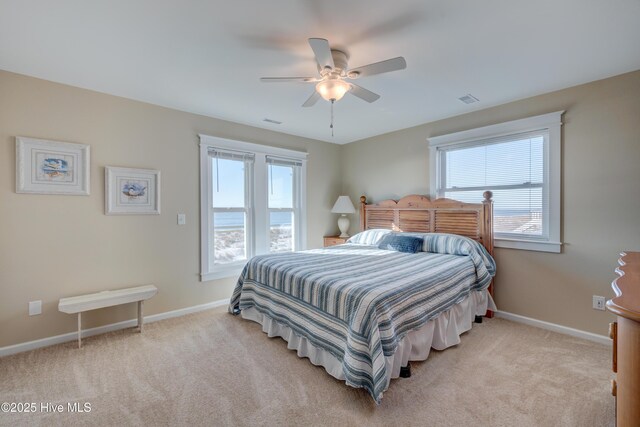 living room with plenty of natural light, light carpet, and ceiling fan