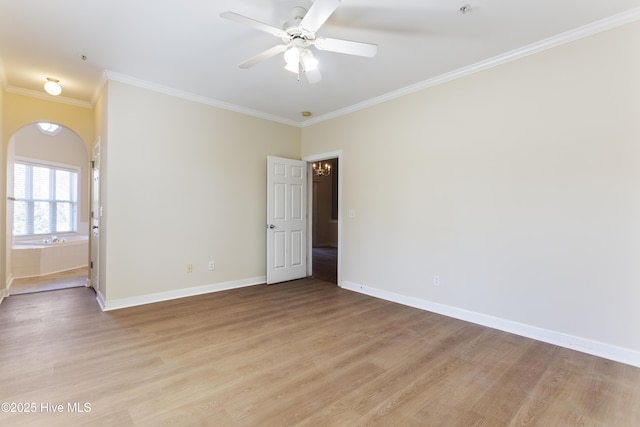 spare room with crown molding, light hardwood / wood-style floors, and ceiling fan