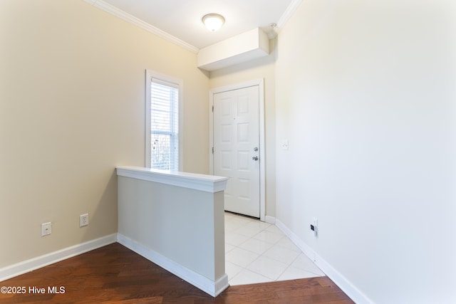 hallway with crown molding and light hardwood / wood-style flooring