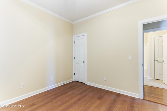 unfurnished room with crown molding and hardwood / wood-style flooring