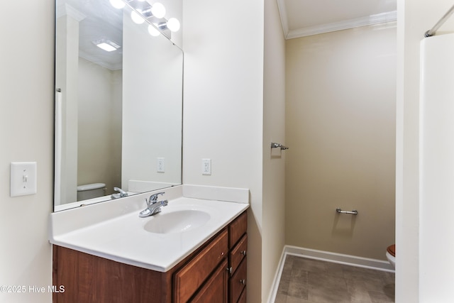 bathroom featuring crown molding, vanity, and toilet