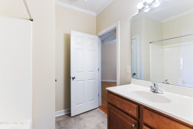 bathroom featuring vanity, crown molding, and a shower